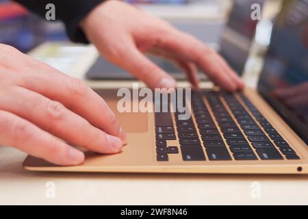 Male hands on laptop keyboard Stock Photo