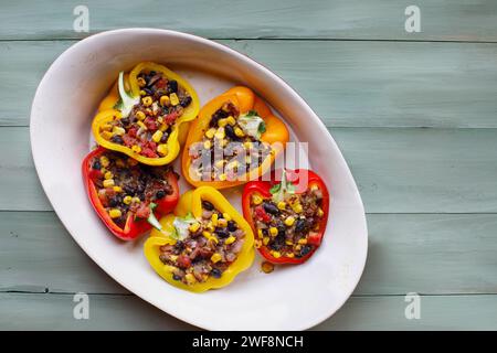 Overhead view of vegan stuffed peppers. These bell peppers have been filled with a southwestern mix of quinoa, corn, black beans, tomatoes and herbs. Stock Photo