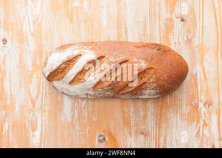 whole grain bread on light wooden surface Stock Photo