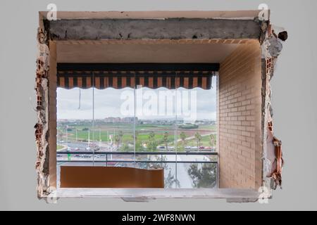 Changing a window in a home with work, chipping walls for a new installation from inside with views to the outside. Home renovation concept Stock Photo