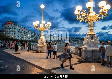 Street lamp at the seaside promenade at dusk, Playa de la Concha, Bahia de la Concha, San Sebastian, Donostia, Camino de la Costa, Camino del Norte, c Stock Photo