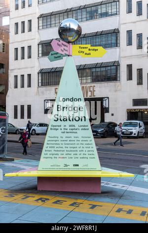 Tooley Street Triangle, street art and large signpost at London Bridge with a bench and local history information, London, England, UK Stock Photo