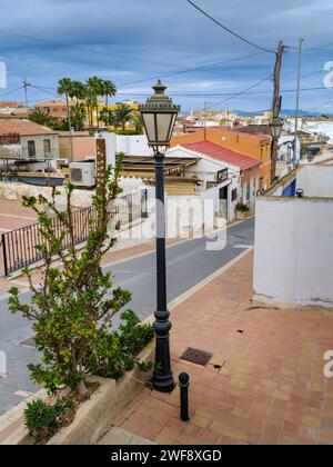 Calle la Cenia - San Miguel de Salinas, Alicante, Spain. One of the picturesque streets lined with a variety of small houses and apartments in San mig Stock Photo