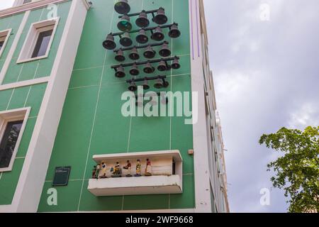Enchanting Clocks on Green Facade of Mikvé Israel-Emanuel Synagogue in Willemstad. Time comes alive in city of Curaçao with sound of bells and music. Stock Photo