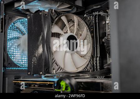 Dust inside of a broken computer. complication of the PC. fan and other computer boards in the dust. Stock Photo