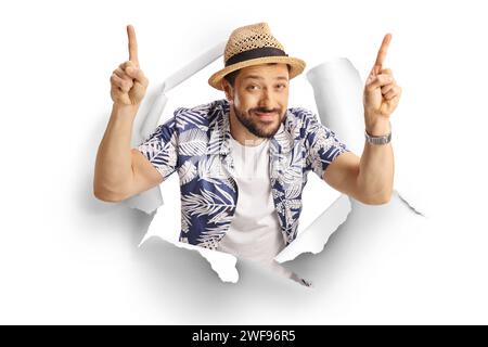 Man peeking through a paper hole and pointing up with both fingers isolated on white background Stock Photo
