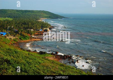 Anjuna Beach. The beaches of Goa are the perfect destination for a relaxing vacation and holiday in India. Water sports and relishing the exotic sea food of Goa, the beaches have everything. Goa is the perfect place to indulge in beach activities with an irresistible combination of silvery sands, palm grooves and the playful sea waves alluring people with their tidal rhythm. Goa, India. Stock Photo