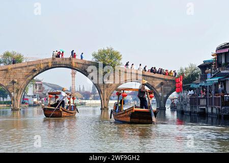 Sightseeing boats take tourists under the famous Fangsheng Bridge in ancient water town of Zhujiajiao located in the Qingpu District of Shanghai. Stock Photo