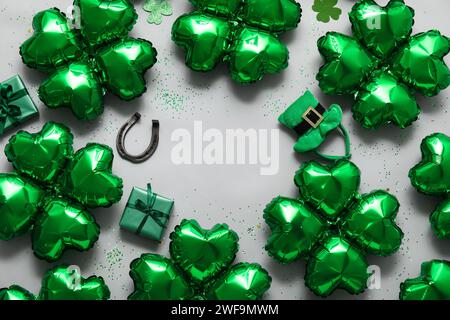 Frame made from balloons in shape of clover on grey background. St. Patrick's Day celebration Stock Photo