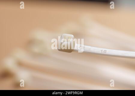 Plastic cable ties. Nylon zip fasteners close up Stock Photo