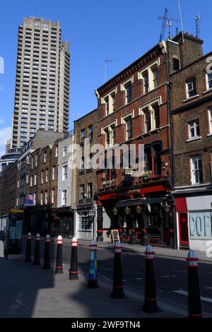 The Old Red Cow pub Long Lane, Smithfield, with the Lauderdale Tower, a 42-story residential building on the Barbican Estate, is visible in the backgr Stock Photo