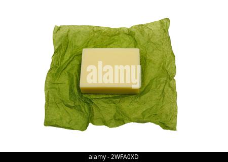 bar of soap on green paper wrapper on white background Stock Photo