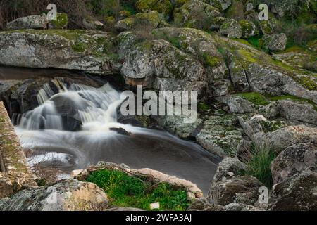 Waterfall formed by the Salor river, at its entrance to the El Gallo reservoir, in Extremadura, Spain. Long exposure photography Stock Photo