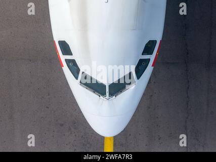 Top down view of Airbus aircraft taxiing underneath Hong Kong Airport Sky Bridge, also know as Chek Lap Kok Sky Deck, above a taxiway. Stock Photo