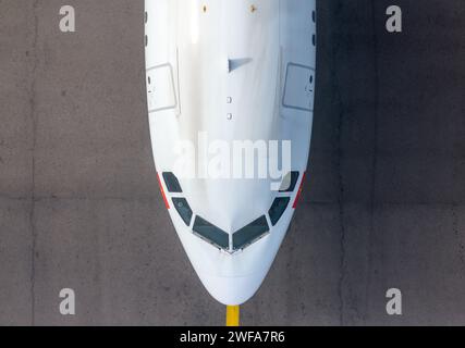 Top down view of Airbus aircraft taxiing underneath Hong Kong Airport Sky Bridge, also know as Chek Lap Kok Sky Deck, above a taxiway. Stock Photo