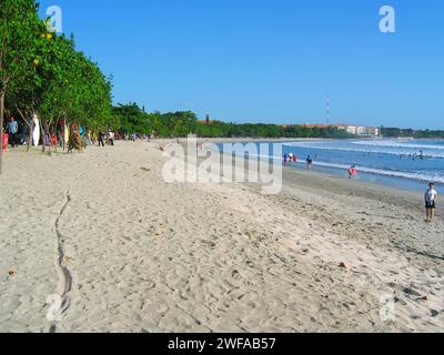 Sunbathers and surfboards on Kuta Beach in Bali, Indonesia. Stock Photo