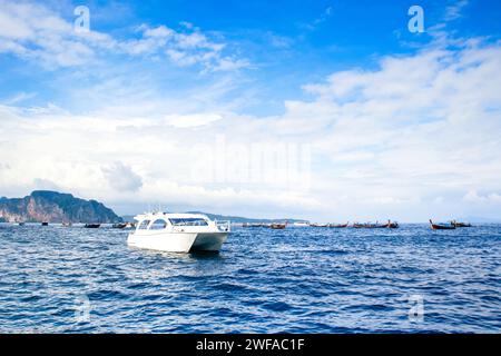 Cruise boats and yachts near Phi Phi islands - one of the most famous places with paradise views and green rocks Stock Photo