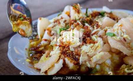 breakfast of chicken porridge topped with crackers and fried peanuts in the morning Stock Photo