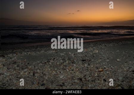 Florida. Sunset on the seashell filled beach of Sanibel Island. Stock Photo