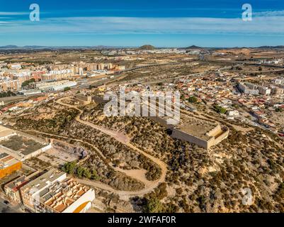 Aerial view of bastioned enclosure fortress on a hill in Cartagena Spain protecting the naval base from the east  with blue cloudy sky Stock Photo