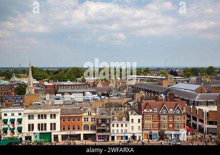 Cambridge, United Kingdom - June 26, 2010: The view of the Market Hill with the prominent spire of the Holy Trinity Church from the St Mary the Great Stock Photo