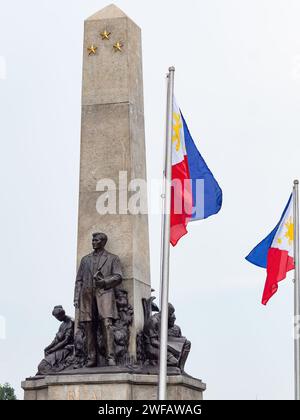 The Jose Rizal Monument and the flag of the Philippines at Rizal Park along Roxas Boulevard in Manila, Philippines. Stock Photo