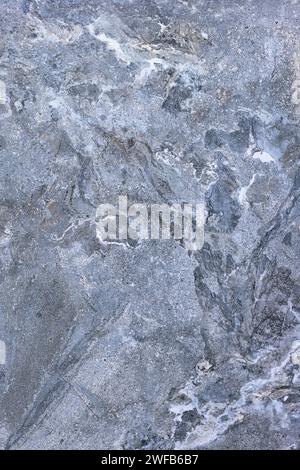 Stone gray-blue marble surface with an abstract pattern in section. Beautiful background close up. Vertical image. Stock Photo