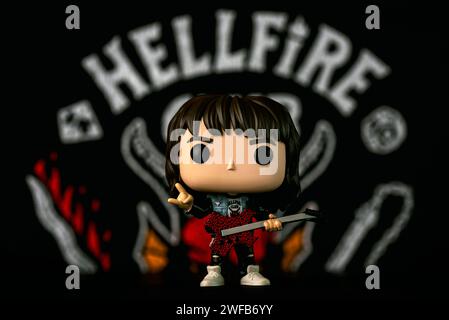 Funko POP vinyl figure of Eddie Munson character of the TV series Stranger Things in front of Hellfire Club poster. Illustrative editorial of Funko Po Stock Photo