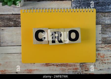 Concept of The wooden Cubes with the word CRO - Conversion Rate Optimization on wooden background. Stock Photo