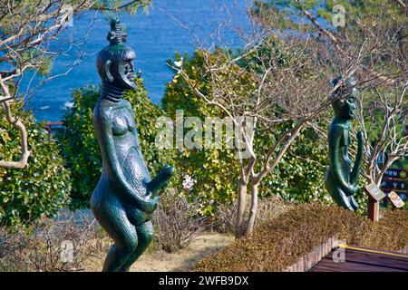 Samcheok City, South Korea - December 28, 2023: A path at Haesindang Park adorned with African-inspired statues of people and phallic figures, with th Stock Photo