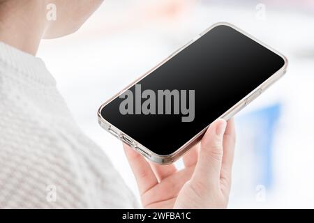 Back view of unrecognizable woman talking phone. Girl looking at her phone. Education online. Mobile phone, Mockup Stock Photo