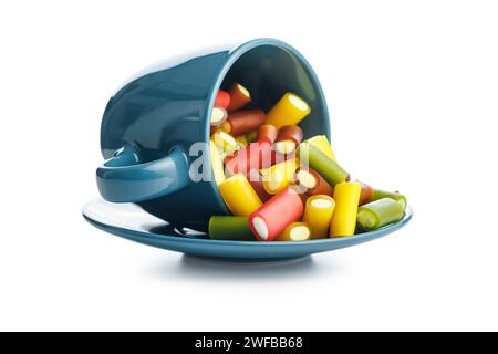 Sweet colorful chewy candy sticks in mug isolated on the white background. Stock Photo