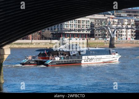 Uber Boat by Thames Clippers after passing under Blackfriars railway bridge approaching the Millennium Bridge, London, England, UK Stock Photo