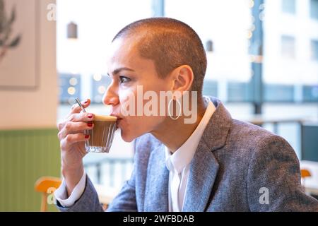 Side view stylish woman drinking coffee in cafe Stock Photo