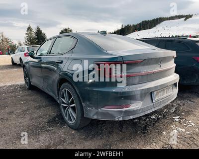 Germany - Jan 21, 2024: An electric exclusive Polestar car parked in the large parking area of Seebach Ski Resort, with a vast slope in the background on a winter frozen day Stock Photo