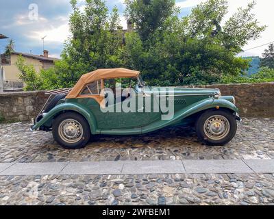 Castell'Arquato, Italy - June 25 2023 vintage old MC TC Midget parked on a pebble street in a medieval village on the hills of Emilia Romagna Italy Stock Photo