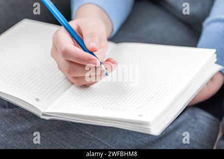 A woman's hand makes entries in a diary Stock Photo