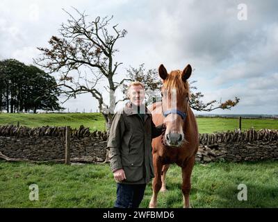 Adam Henson on his farm with one of his horses Stock Photo