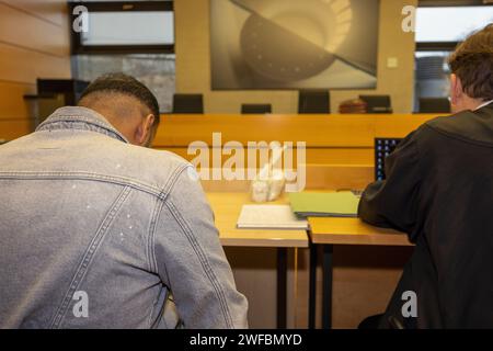 30 January 2024, Bavaria, Würzburg: The defendant (l) sits with his lawyer Martin Reitmaier in the courtroom at Würzburg Regional Court. More than ten months after the fatal stabbing of a woman in Lower Franconia, the district court is hearing the case against her husband. The public prosecutor is accusing the 36-year-old of murder. Photo: Heiko Becker/dpa Stock Photo