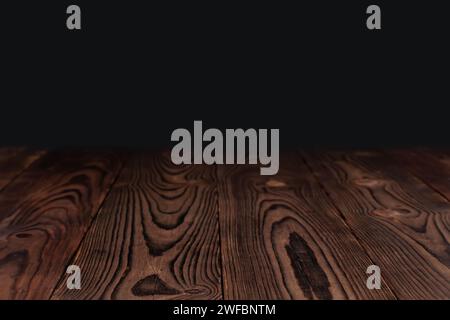 empty wooden table float up on dark background. Stock Photo