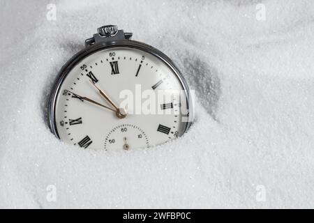 Pocket watch buried in sand. Old watch lost in the sand Stock Photo