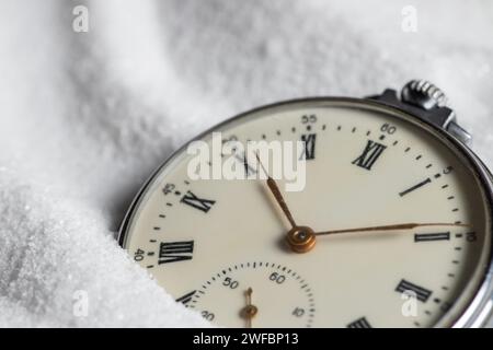 Pocket watch buried in sand. Old watch lost in the sand Stock Photo