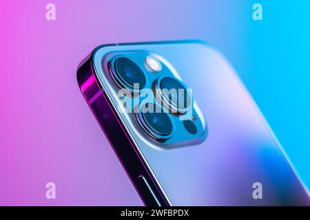 Macro Shot of Triple-Lens iphone 14 pro max Smartphone Camera on Gradient Background Stock Photo