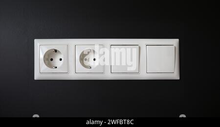 Integrated socket with switches installed in wall Stock Photo