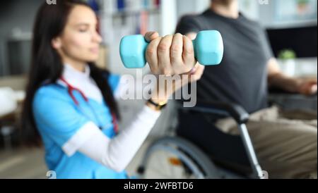 Man on stroller doing exercises with dumbbells Stock Photo