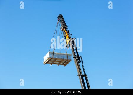 Crane moves large electrical component for radio wave repeater Stock ...