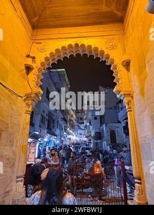 Night view of the people in the market near Gangaur Ghat near lake Pichola in Udaipur, Rajasthan, India Stock Photo