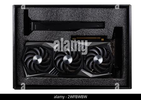 Video card in box for modern video games and cryptocurrency mining. The new video card with three coolers is opened from a cardboard box Stock Photo