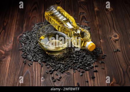 Organic sunflower oil in a glass bowl and bottle with sunflower seeds Stock Photo
