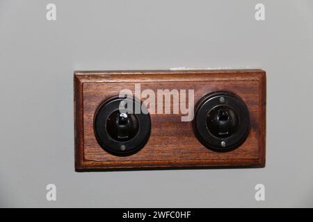 A Pair of Vintage Plastic Light Switches on a Wood Board. Stock Photo